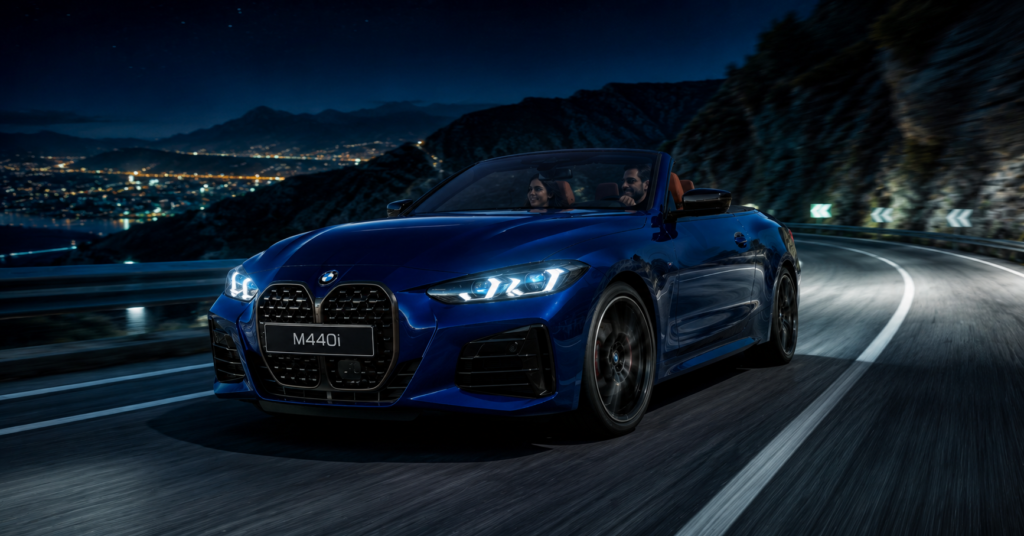 BMW M440i 2026 convertible night driving shot on mountain road with LED headlights